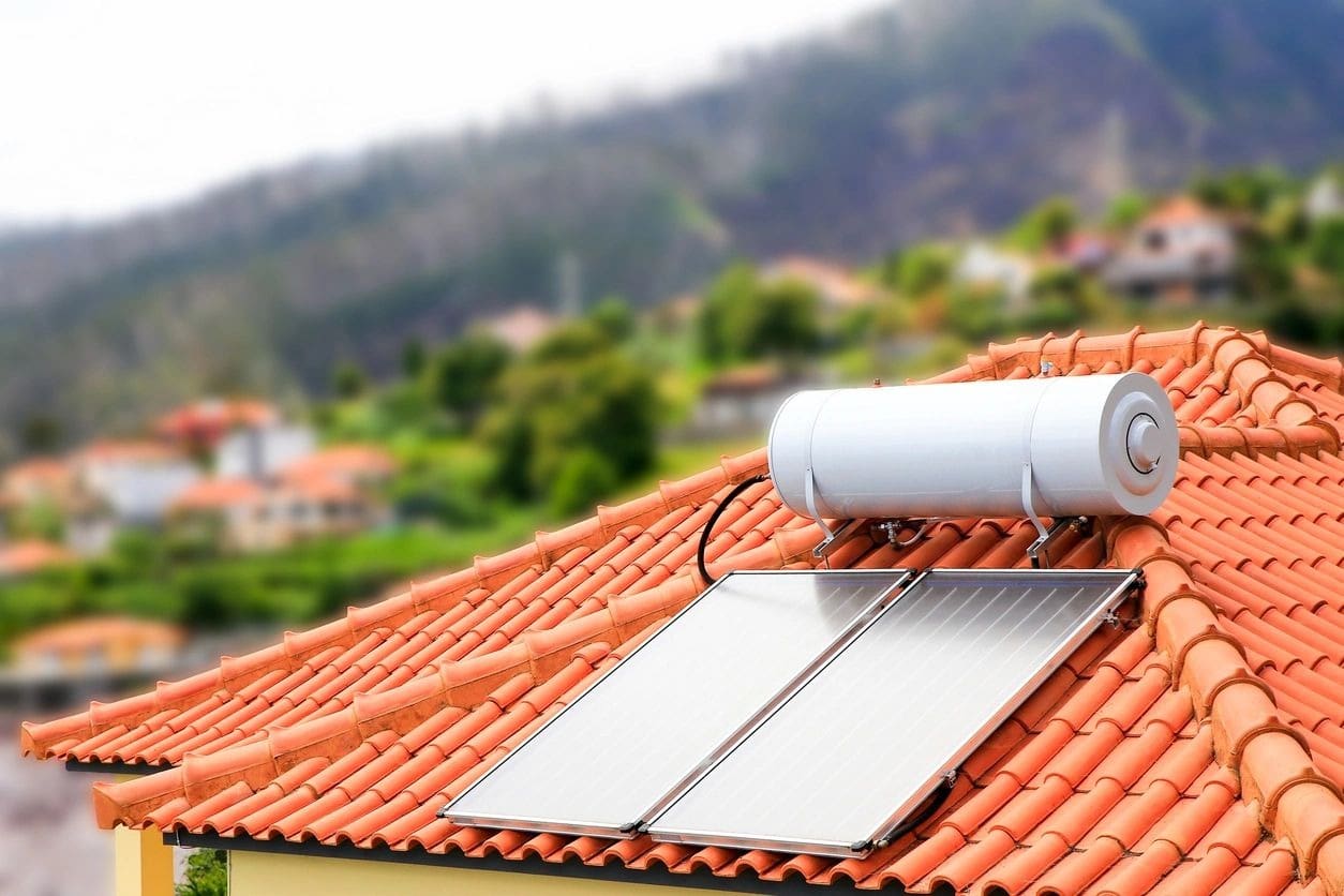 A solar water heater on the roof of a house.
